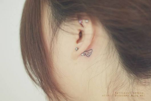 Delicate behind the ear tattoo