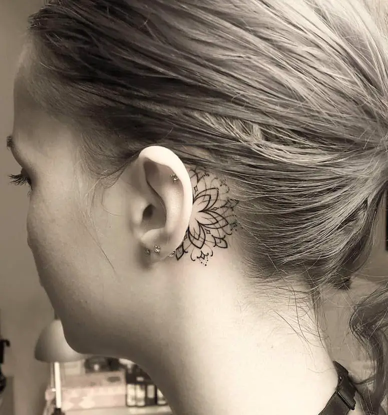 Delicate behind the ear tattoo