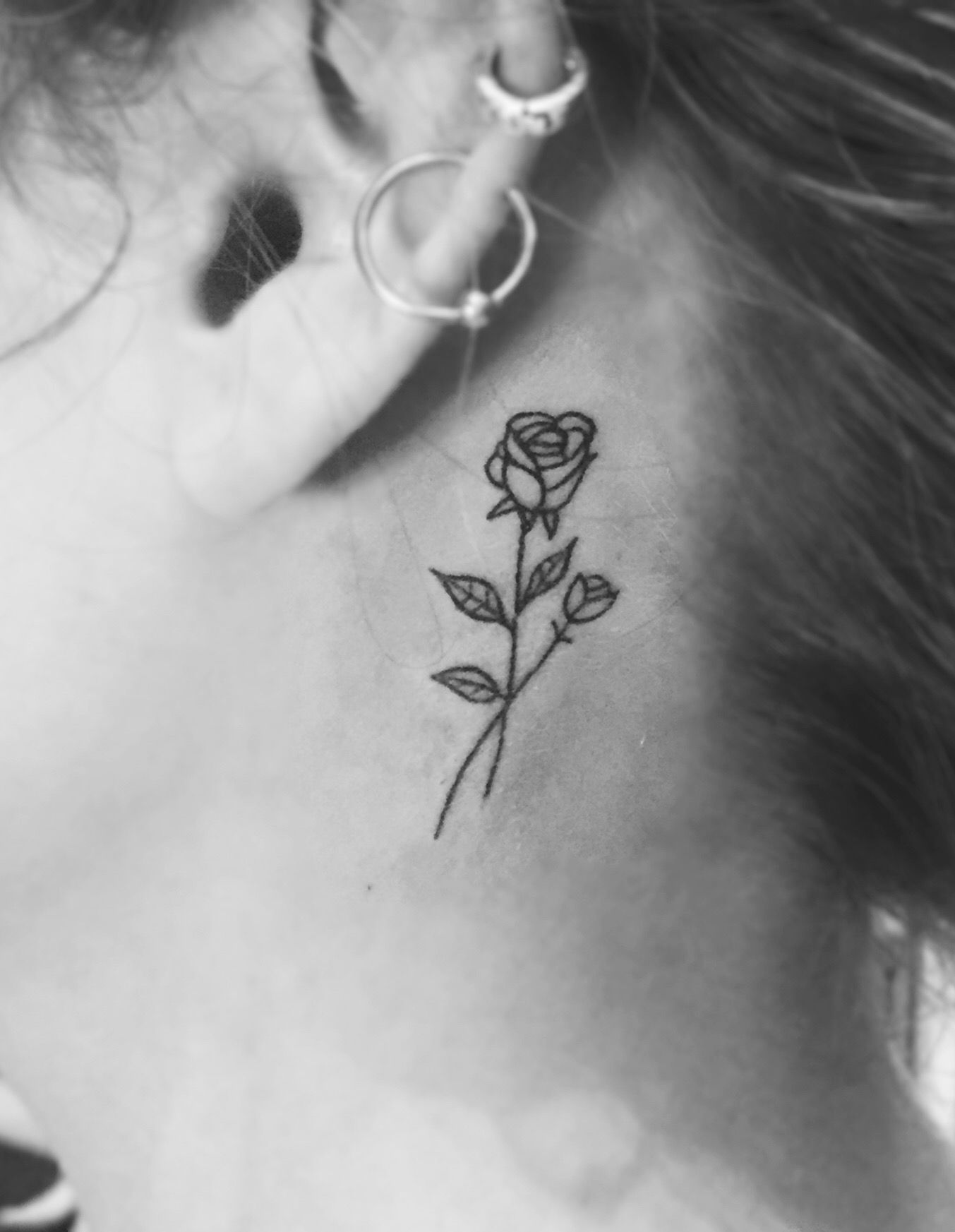 flower behind ear tattoo