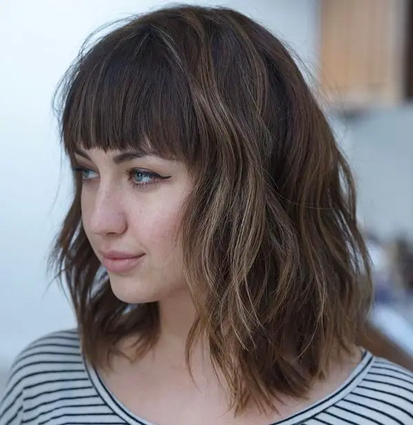 Long bob hair with bangs seen from the side